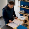 Le responsable du garage passe en revue les comptes et analyse les chiffres pour assurer la bonne gestion financière de l'établissement.