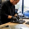 Mains préparant un kit de réparation de pare-brise sur l'établi