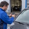 Technicien prenant en photo un impact sur un pare-brise